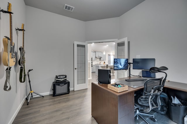 office space with hardwood / wood-style flooring and french doors