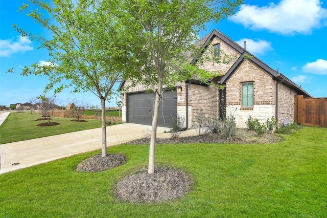 view of front facade with a garage, fence, concrete driveway, brick siding, and a front lawn