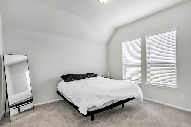 bedroom with light carpet and lofted ceiling