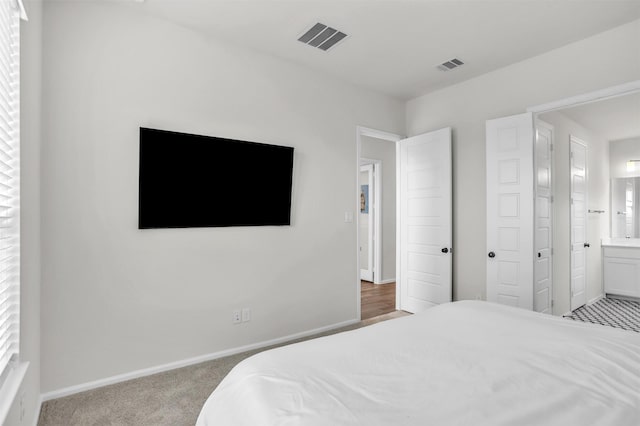 carpeted bedroom with ensuite bathroom