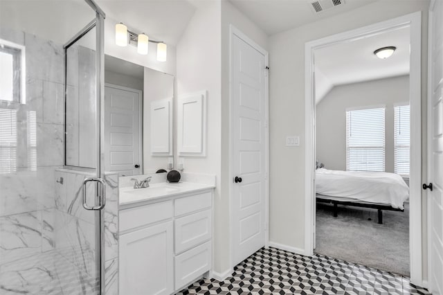 bathroom featuring vanity and an enclosed shower