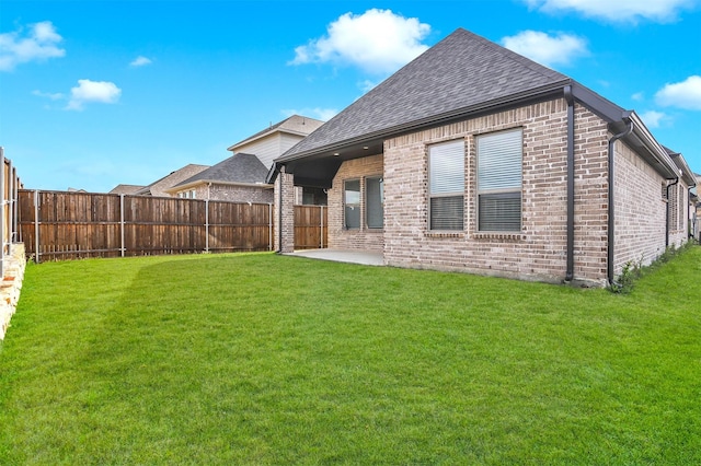 back of property featuring a patio area and a yard