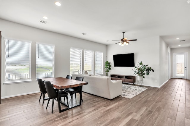 living room featuring ceiling fan and light wood-type flooring