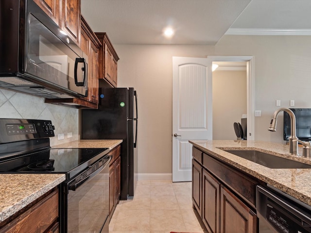 kitchen featuring light stone countertops, sink, decorative backsplash, black appliances, and ornamental molding