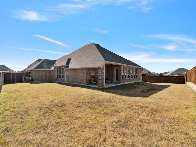 back of house with a lawn, a patio area, and central air condition unit