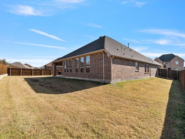 rear view of property with a yard