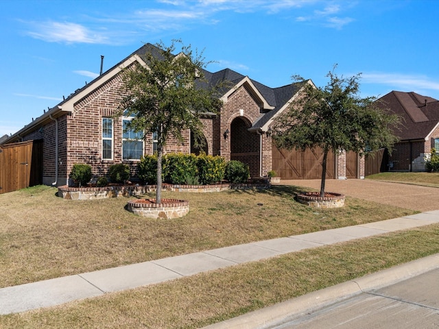 view of front of property featuring a garage and a front lawn