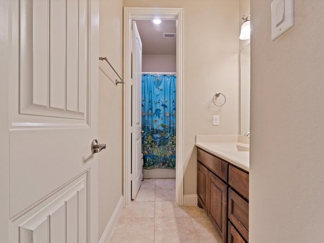 bathroom with a shower with curtain, tile patterned flooring, and vanity