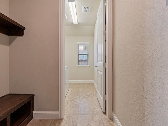 hall with light tile patterned flooring