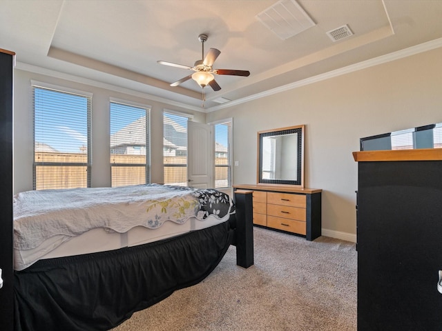 carpeted bedroom featuring ceiling fan, a raised ceiling, and crown molding