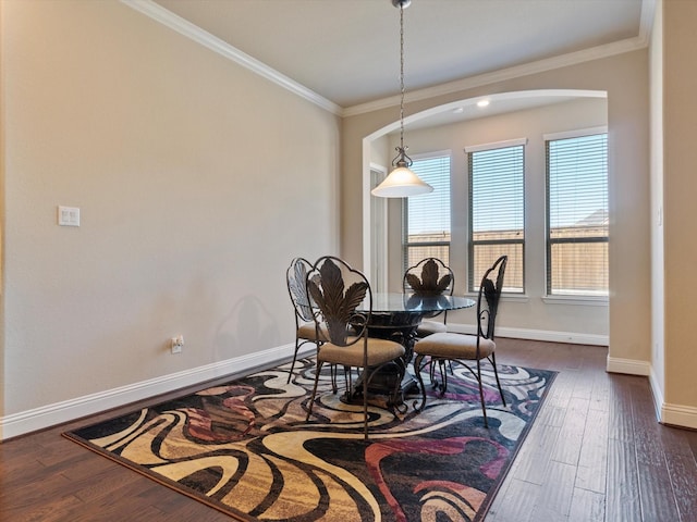 dining room featuring dark hardwood / wood-style flooring and ornamental molding