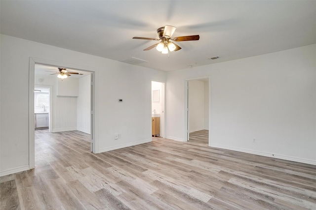 empty room with light hardwood / wood-style flooring, ceiling fan, and sink