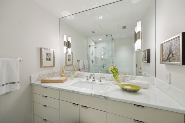 bathroom featuring tile patterned floors, vanity, and walk in shower