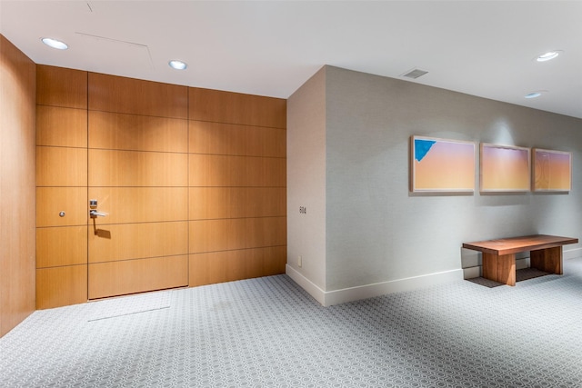 hallway with light colored carpet