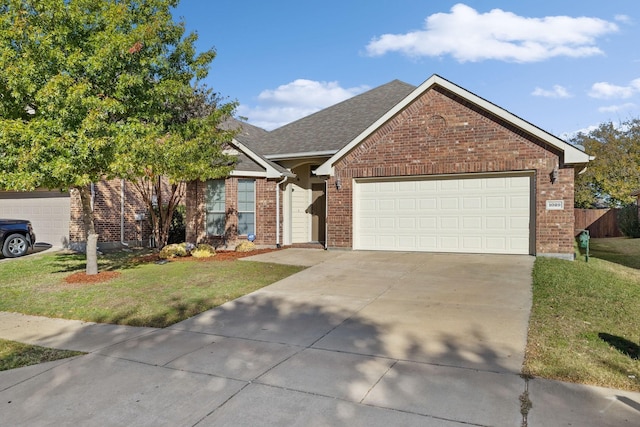 view of front of house with a garage and a front lawn