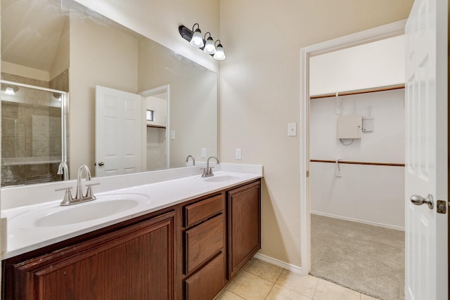 bathroom featuring tile patterned flooring, vanity, and a shower with door