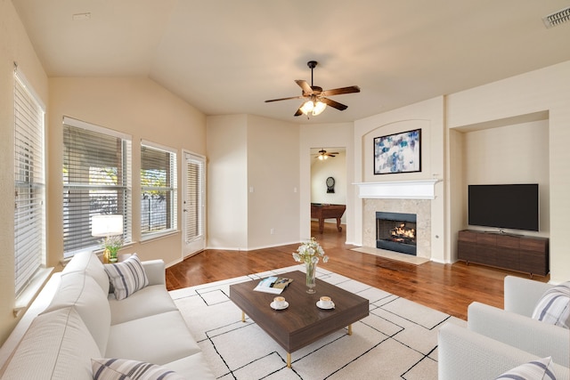 living room with light wood-type flooring, vaulted ceiling, and ceiling fan