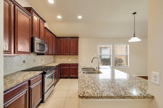 kitchen with sink, light stone counters, an island with sink, decorative backsplash, and appliances with stainless steel finishes