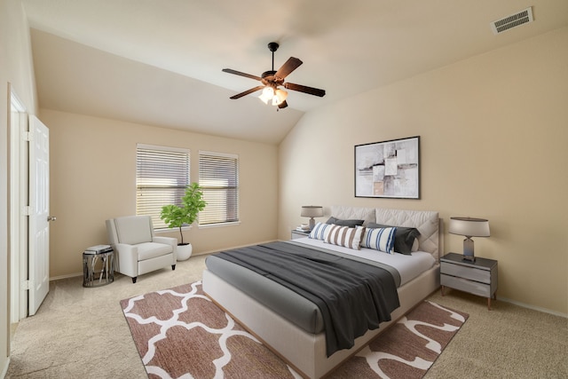 bedroom featuring ceiling fan, light colored carpet, and lofted ceiling