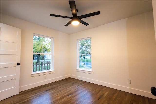 unfurnished room featuring ceiling fan and dark wood-type flooring