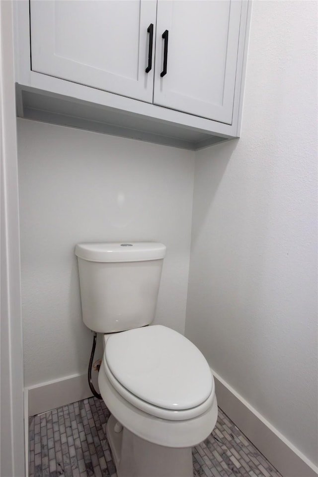 bathroom featuring tile patterned floors and toilet