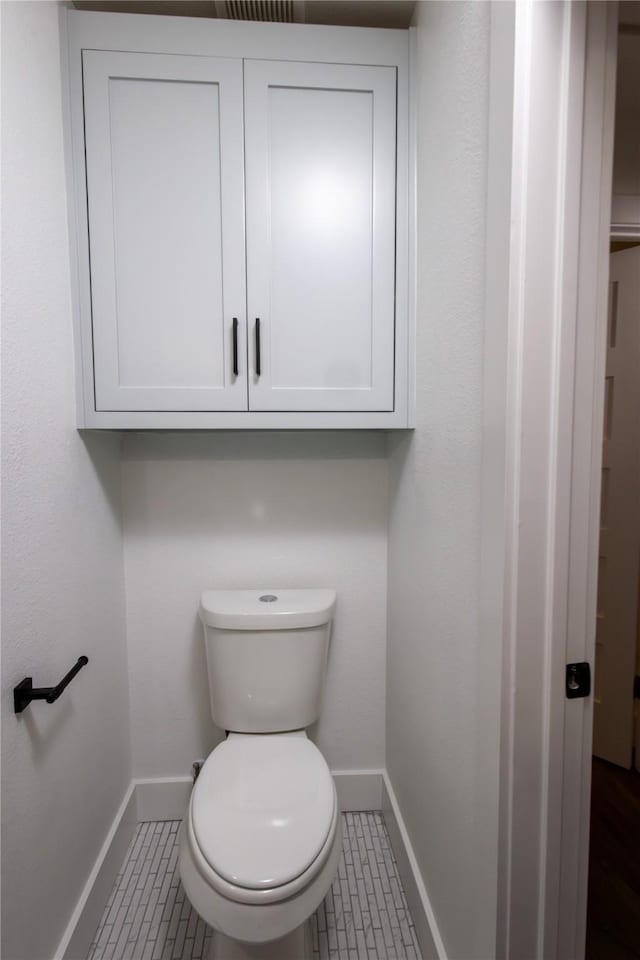 bathroom featuring tile patterned flooring and toilet