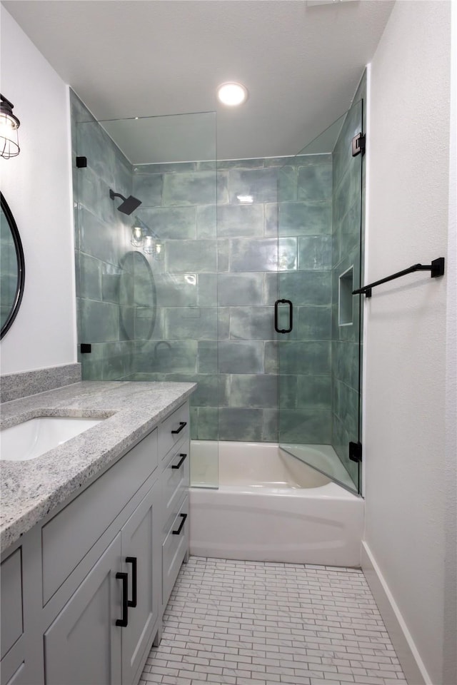 bathroom with tile patterned floors, vanity, and enclosed tub / shower combo