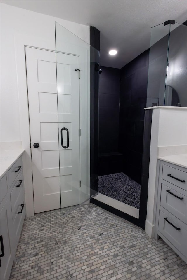 bathroom featuring vanity and a shower with shower door