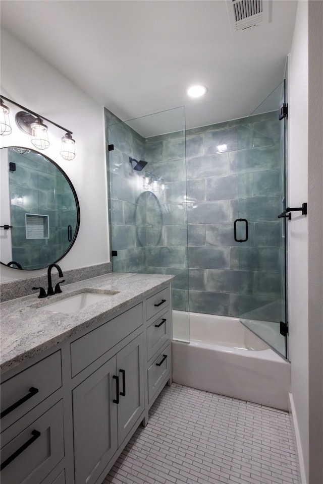 bathroom featuring tile patterned floors, vanity, and bath / shower combo with glass door