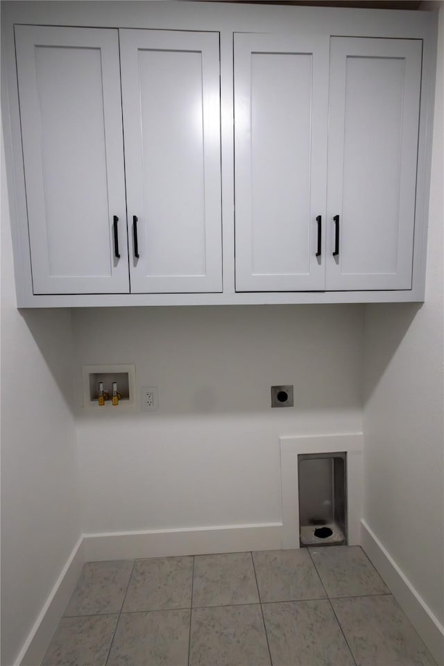 washroom featuring cabinets, washer hookup, electric dryer hookup, and light tile patterned flooring