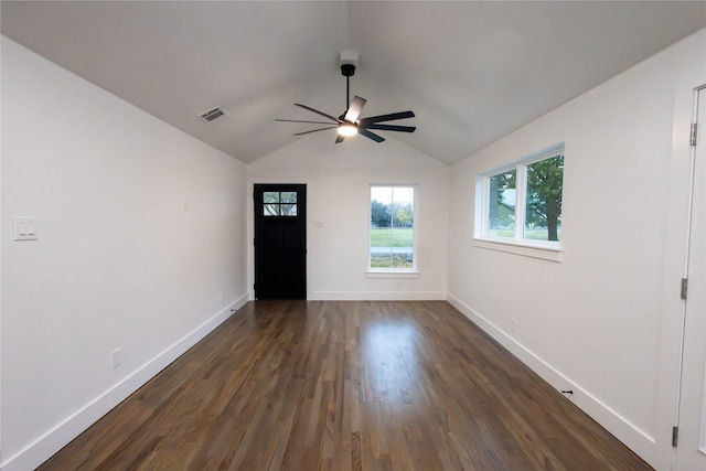 empty room featuring ceiling fan, lofted ceiling, and dark wood-type flooring