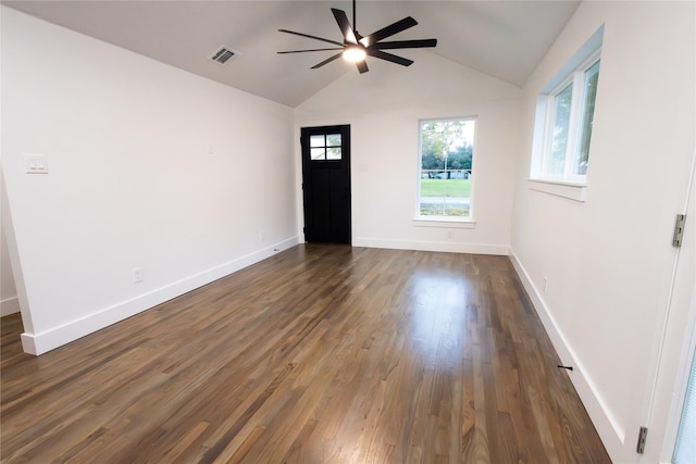 empty room with vaulted ceiling, ceiling fan, and dark wood-type flooring