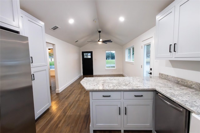 kitchen featuring lofted ceiling, kitchen peninsula, stainless steel appliances, and dark wood-type flooring