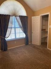 unfurnished bedroom featuring dark colored carpet