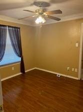 empty room with dark hardwood / wood-style floors, ceiling fan, and ornamental molding