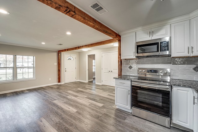 kitchen featuring beam ceiling, white cabinetry, light hardwood / wood-style flooring, backsplash, and appliances with stainless steel finishes