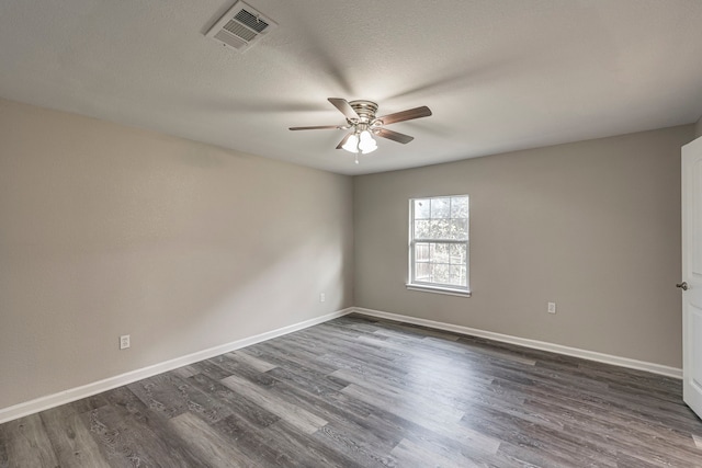 unfurnished room featuring a textured ceiling, ceiling fan, and dark wood-type flooring