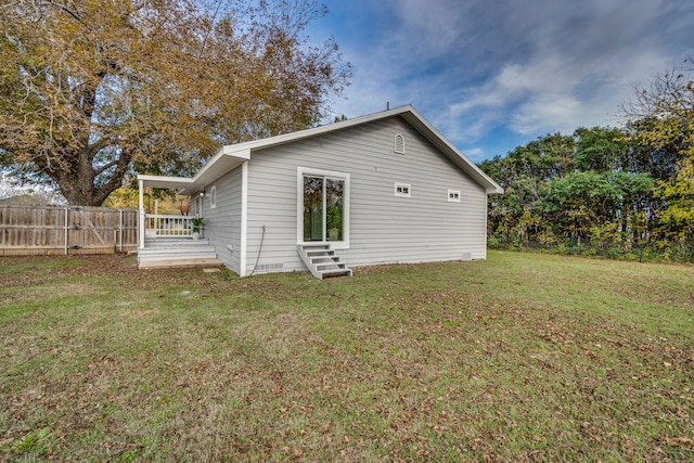 rear view of house with a lawn