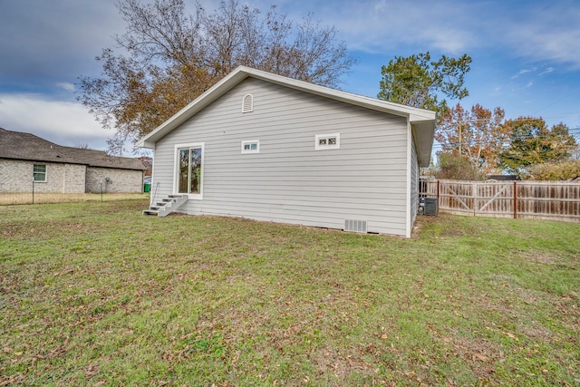 exterior space with a lawn and central AC unit