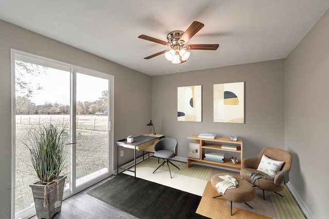 home office featuring wood-type flooring and ceiling fan