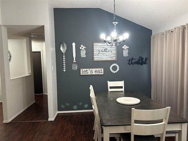 dining space with a chandelier, a textured ceiling, lofted ceiling, and dark wood-type flooring