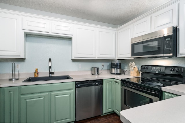 kitchen featuring white cabinetry, appliances with stainless steel finishes, sink, and a textured ceiling