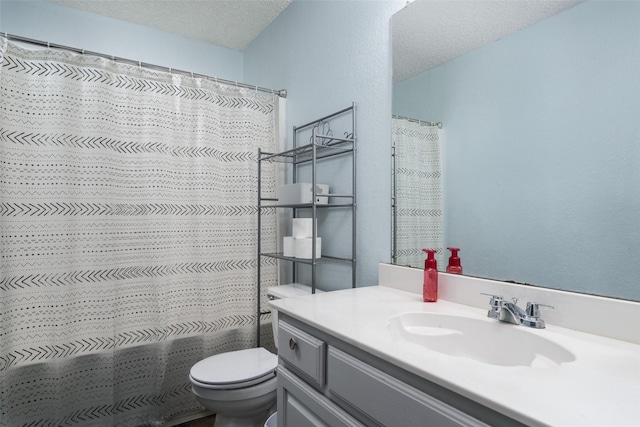 bathroom with a shower with curtain, vanity, toilet, and a textured ceiling