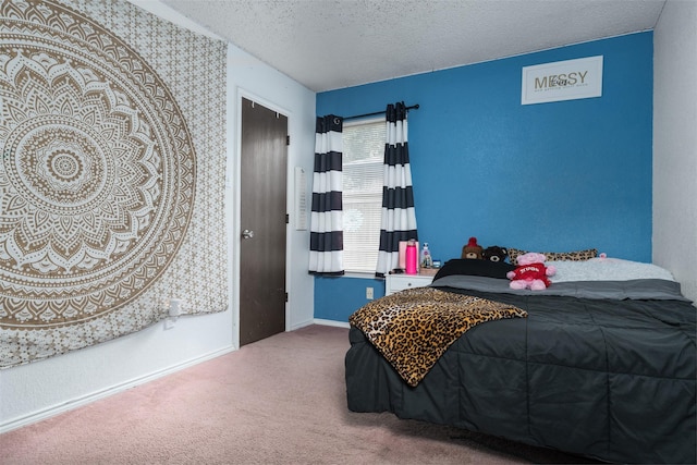 bedroom with carpet floors and a textured ceiling