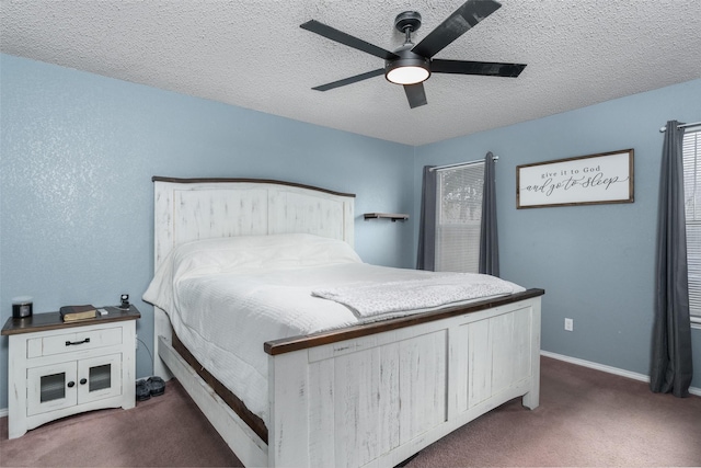 carpeted bedroom featuring ceiling fan and a textured ceiling