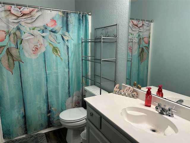 full bathroom with hardwood / wood-style floors, vanity, toilet, and shower / bath combo