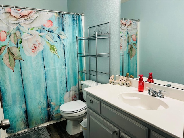 full bathroom with vanity, wood-type flooring, shower / tub combo, and toilet