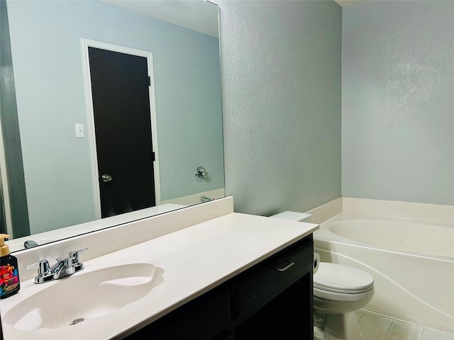 bathroom featuring a tub to relax in, tile patterned flooring, vanity, and toilet