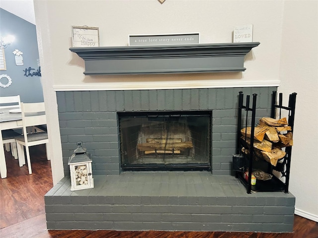 details featuring a fireplace and wood-type flooring