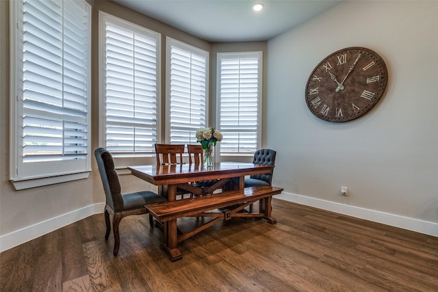 dining space with wood-type flooring